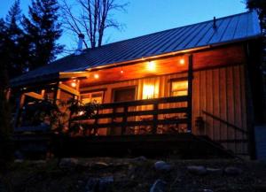 a small cabin with lights on the front of it at Packwood Ski & Vacation Getaway in Packwood