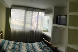 a bedroom with a window with a bed and a television at Beautiful Apartment San Jose Downtown South in San José