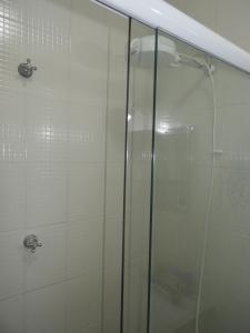 a shower with a glass door in a bathroom at ACIOLY'S BEACH HOUSE in Caraguatatuba