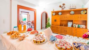 a table with many plates of food on it at Hostal San Francisco in Cala d´Or