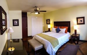 a bedroom with a large bed and a ceiling fan at Humuya Inn in Tegucigalpa