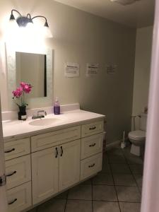 a bathroom with a sink and a mirror and a toilet at Hollywood Stay in Los Angeles