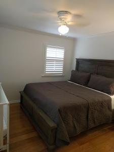 a bedroom with a large bed and a window at University City Guest House in Charlotte
