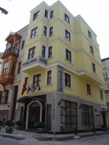 a yellow building on the corner of a street at Hotel Nova in Istanbul