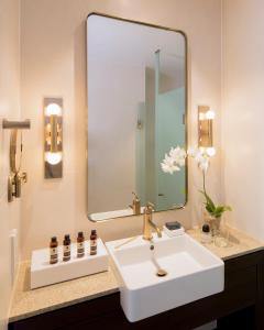 a bathroom with two sinks and a mirror at The William Inglis Mgallery By Sofitel in Warwick Farm
