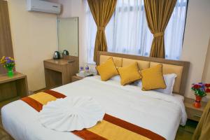 Postel nebo postele na pokoji v ubytování Sakura Boutique Hotel