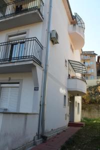 a white building with two balconies on the side of it at Calm Apartment in Belgrade