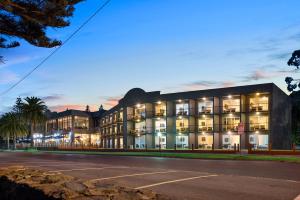 a building with a parking lot in front of it at North Pier Hotel in Cowes