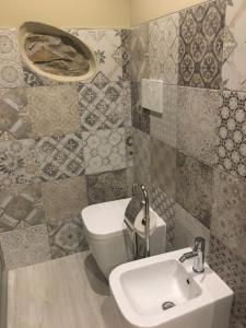 a bathroom with a sink and a toilet at Casa D'amore in Riomaggiore
