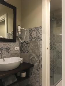 a bathroom with a sink and a glass shower at Casa D'amore in Riomaggiore