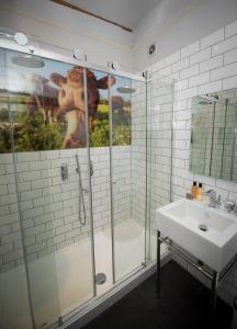 a bathroom with a shower and a sink at The Bull Inn in Mildenhall