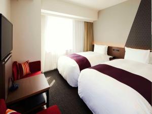 Postel nebo postele na pokoji v ubytování Hotel Intergate Tokyo Kyobashi