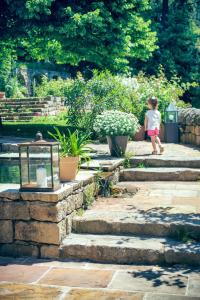 a little girl walking down a set of stone stairs at Le Domaine du Fayet in Sanilhac