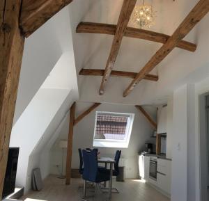a kitchen with wooden beams and a table and chairs at Ferienwohnung Kiel - Kanalblick in Kiel