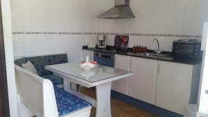 a small kitchen with a table and a sink at Morisca in Lloret de Mar