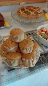 a bunch of muffins on a plate on a table at AL 32 B&B in Massa Marittima