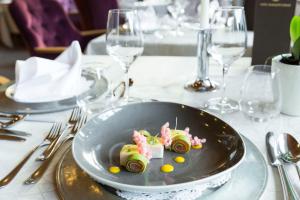 a plate of food on a table at a restaurant at Hotel Burggräflerhof in Merano