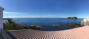 a view of the ocean from a building at A Villa by the Sea Bed & Breakfast in Vila Franca do Campo