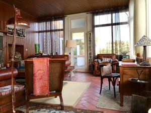 a living room filled with furniture and windows at A Villa by the Sea Bed & Breakfast in Vila Franca do Campo