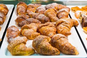 a display of different types of donuts and pastries at Hotel Montecarlo in Bibione