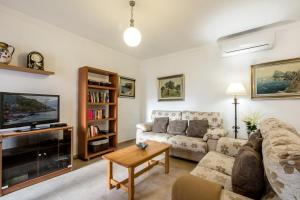 a living room with a couch and a tv at Bewitched Granny's House in Pollença