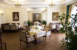 a dining room with tables and chairs in a restaurant at Alanda Hotel in Astana