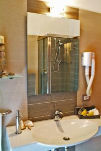 a bathroom with a sink and a mirror at Hotel Villa Paola in Rimini