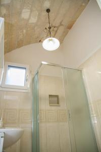a bathroom with a shower and a sink and a ceiling at Le Tenute di Agnese in Felline +77 photos
