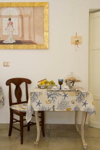 a table and a chair with a table and a mirror at Le Tenute di Agnese in Felline