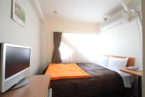 מיטה או מיטות בחדר ב-Sakura Hotel Hatagaya