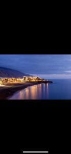 a picture of a beach with lights on the water at Playa Nieves in Puerto Naos