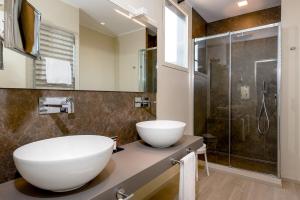 a bathroom with a large white sink and a shower at Hotel Canada in Milan