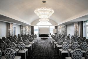 a conference room with chairs and a projection screen at Lochside House Hotel & Spa in New Cumnock