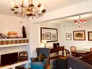 a living room with a chandelier and a table at Casa Rural Finca Buenavista in Valdeganga de Cuenca
