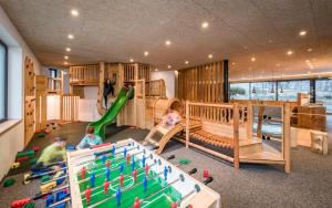 a group of children playing in a room with play equipment at Hotel Lener in Campo di Trens