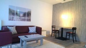 a living room with a couch and a table at dat geele hus Wohnung Nr. 4 in Büsum