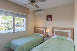 a bedroom with two beds and a window at Cubo's Villa Marieli Chilches in Chilches +40 photos