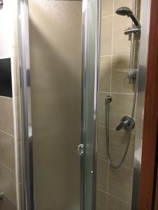 a shower with a glass door in a bathroom at I Visconti in Naples