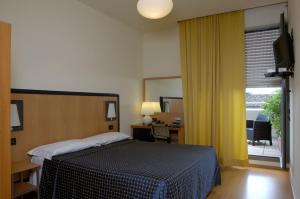 Posteľ alebo postele v izbe v ubytovaní Hotel Masini