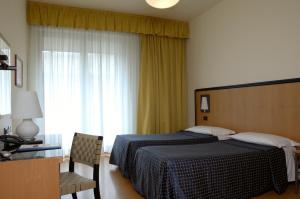 Posteľ alebo postele v izbe v ubytovaní Hotel Masini
