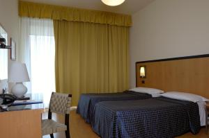 Posteľ alebo postele v izbe v ubytovaní Hotel Masini