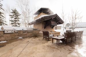 a outdoor grill with a table and chairs in the snow at Silver Strike #702 - 1 Bed in Park City