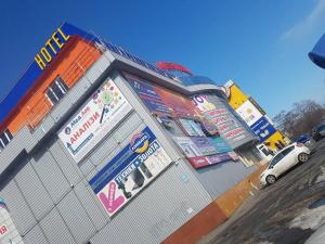 a building with a fence on the side of a street at HOTEL Bee Station in Kyiv