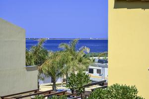a view of a resort with the ocean in the background at Torre Sances House in Birgi Vecchi