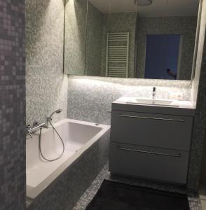 a bathroom with a tub and a sink and a bath tub at Chantal in Brun Culot