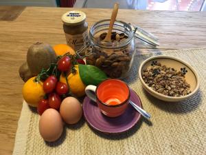 a table with eggs fruits and nuts and a cup of coffee at B&B Corte Dei Musco in Lecce