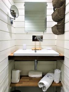 a bathroom with a sink and a mirror and towels at Studio La Voile Blanche in Orient Bay French St Martin