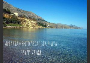 uitzicht op een meer met bergen op de achtergrond bij Appartamento Spiaggia Playa in Castellammare del Golfo