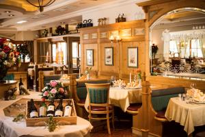 a restaurant with two tables with bottles of wine at Appartement Hanneshof in Filzmoos