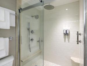 a bathroom with a shower with a glass door at Seaport Hotel® Boston in Boston